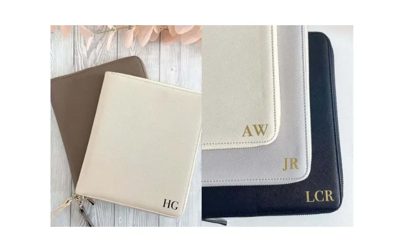 Metallic initials on light and dark leather accessories